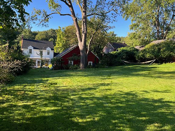 View of the garage and house from the expansive lawns.