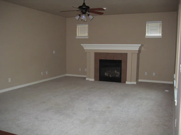 Great room with fireplace and ceiling fan
