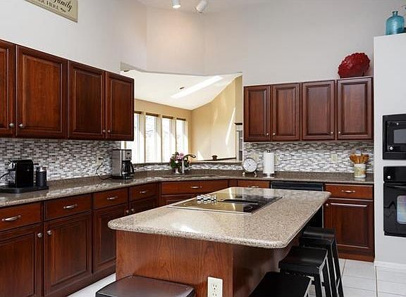 Great kitchen with newer quartz counters, ceramic flooring and splash, black appliances. Breakfast b
