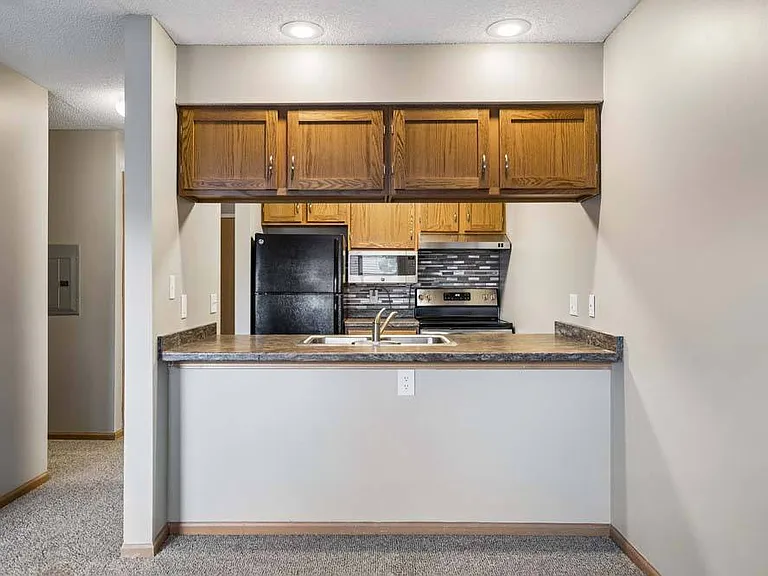 The breakfast bar creates a natural gathering place, while the thoughtfully designed kitchen offers everything you need for easy everyday living.