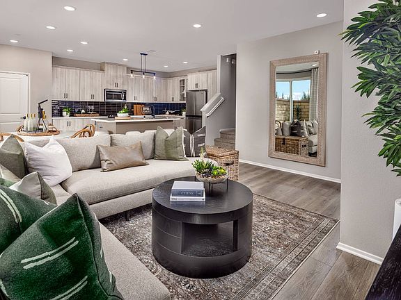 An image of the great room with a view of the kitchen in the Plan 5 model home at Row in New Haven.