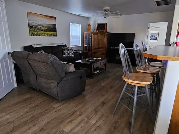 Living room, with open bar to kitchen.