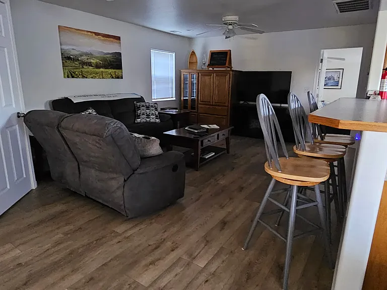 Living room, with open bar to kitchen.