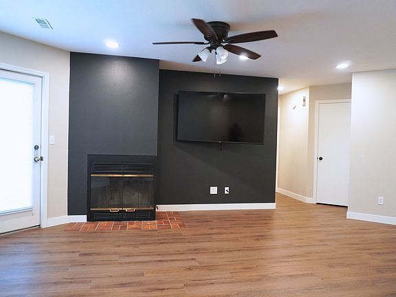 Spacious living room with easy access to the outdoor screened-in porch on the first level_perfect for relaxation! Please note, the TV is not included and fireplace is not functionable