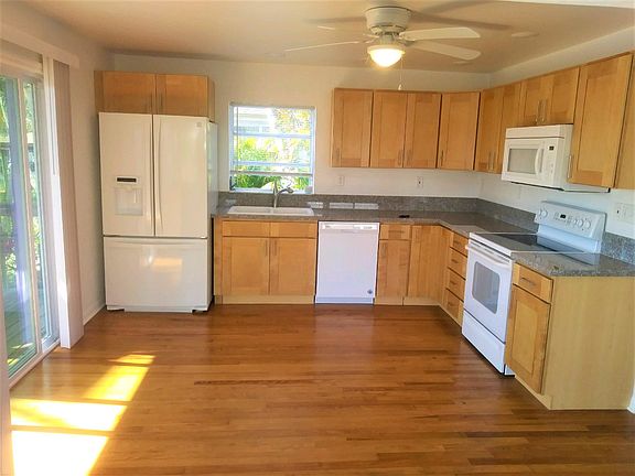 Fully-equipped, newly remodeled kitchen (less than 1 year old). Sliders on left lead to the canal-front deck.