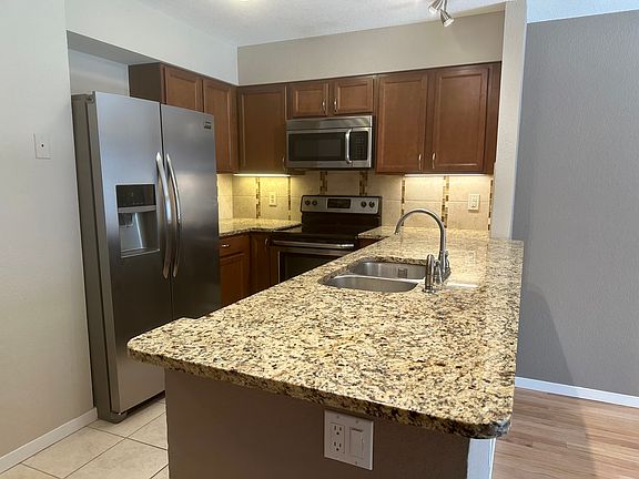 Kitchen with granite countertops, stainless steel large refirgerator