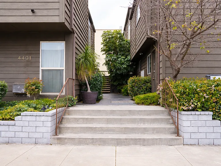 Well maintained community entrance with landscaped walkway.