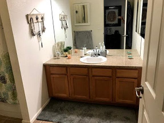 restroom with granite counter tops