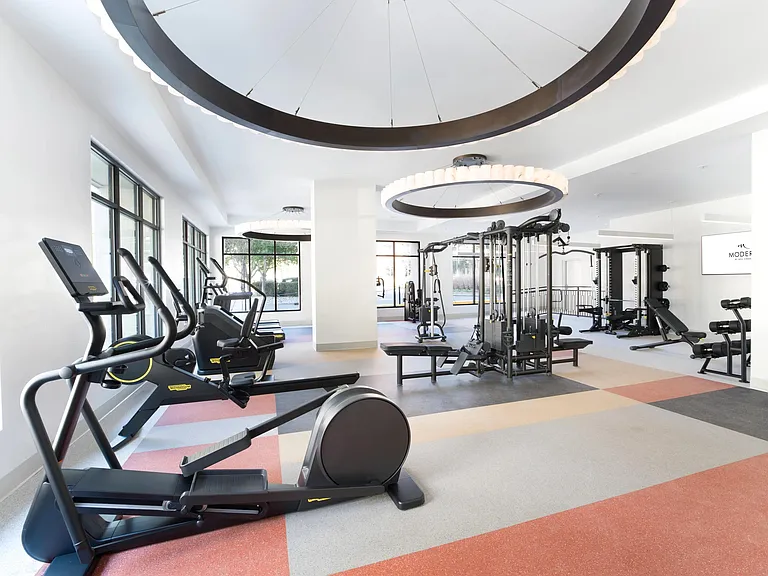 A light-filled fitness studio with modern cardio and strength equipment, designed for everything from quick workouts to full training sessions.