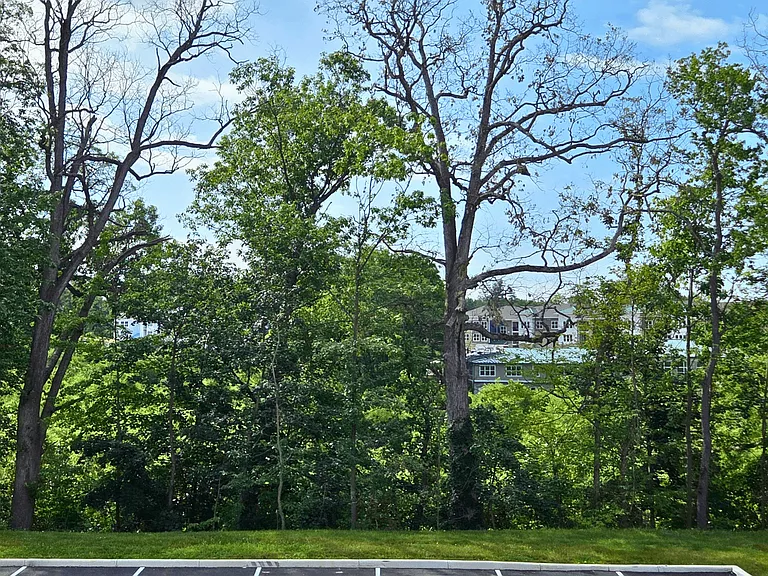Enjoy wooded views from your new patio/balcony, available at select units at Greenwood Commons Apartments.