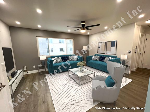 Large living room with plenty of can lights and windows