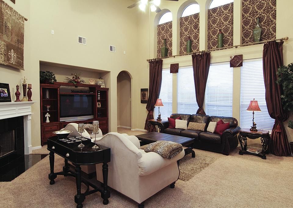 Living Room - This two story living room is completely picturesque, from the wall of windows, to the neutral colors & designer marble fireplace!