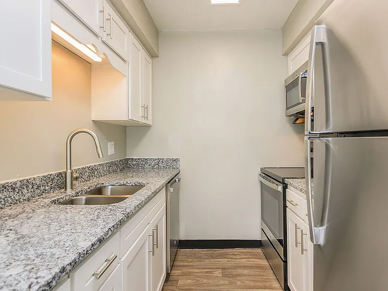 Kitchen with granite counters, stainless appliances, and modern cabinetry