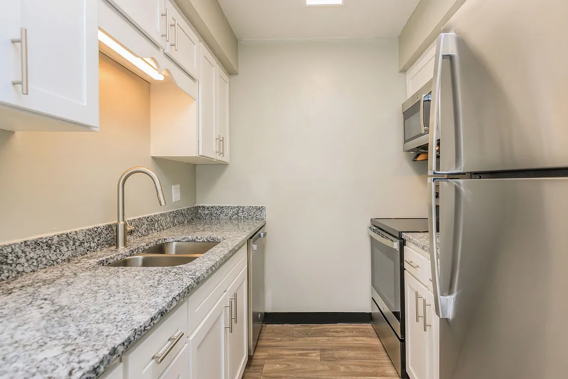 Kitchen with granite counters, stainless appliances, and modern cabinetry