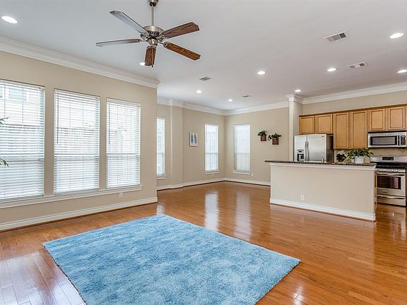 This home's open floor plan is perfect for both easy living and entertaining. The rooms are spacious, have high ceilings and are filled with wonderful, natural light from the numerous windows.
