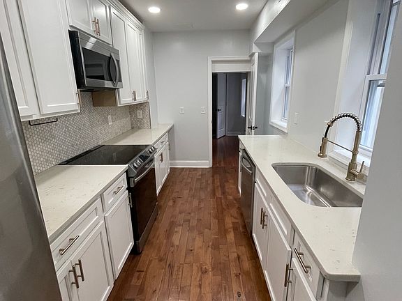 Beautiful renovated kitchen with natural light and stainless steel new appliances
