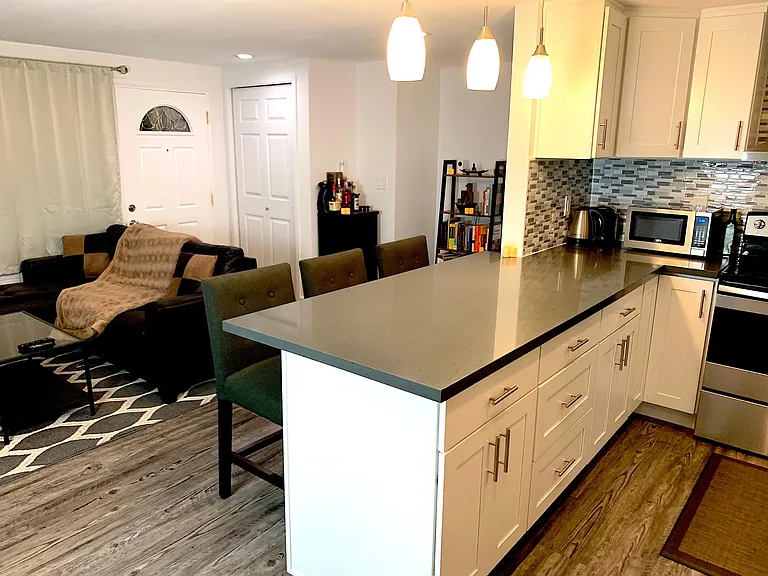 Open concept kitchen with new quartz countertops and backsplash