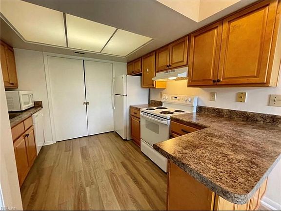 kitchen with fridge and microwave, sliding door to washer and dryer
