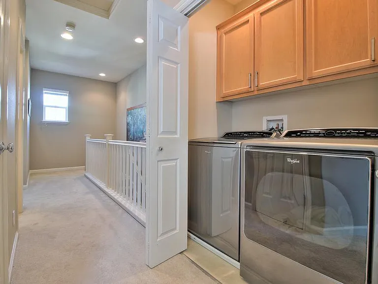 Laundry area with linen closet opposite it