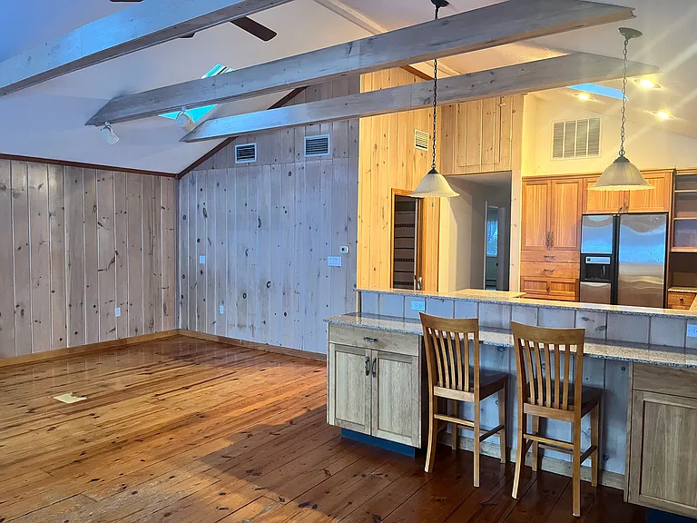 Kitchen from in front of sliders, showing living room area.