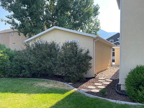 Breezeway between home and garage leads out to large unfenced yard