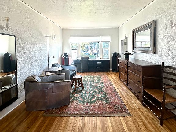 Living room 1 (part of an open primary suite), with courtyard views and abundant light