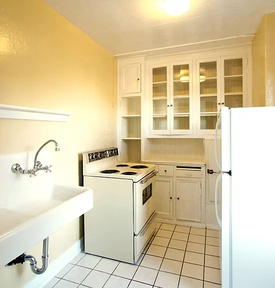 Charming kitchen with glass front cabinets and original porcelain farm sink