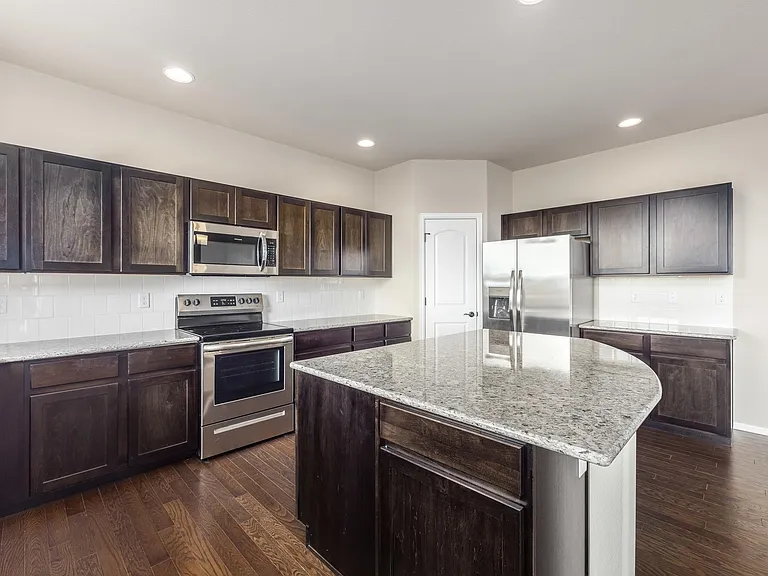 Beautiful Open Kitchen with Expresso Cabinets, Granite Countertops and LVP Flooring