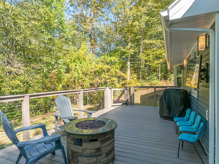 Trex Deck, propane firepit, TV with exterior speakers, and Blackstone grill connected to natural gas