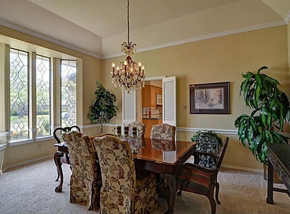 Lovely Formal Dining features Leaded Glass Bay Window & Custom Chandelier!