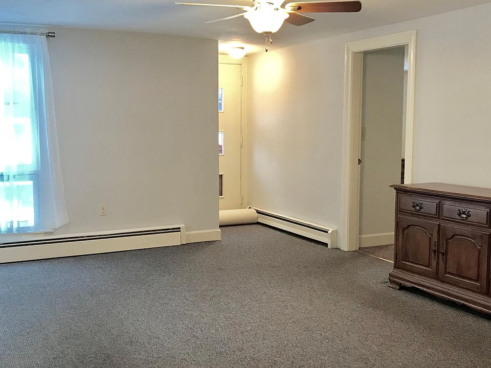 View from kitchen. Spacious living room with large picture windows . Baseboards - oil w heat included