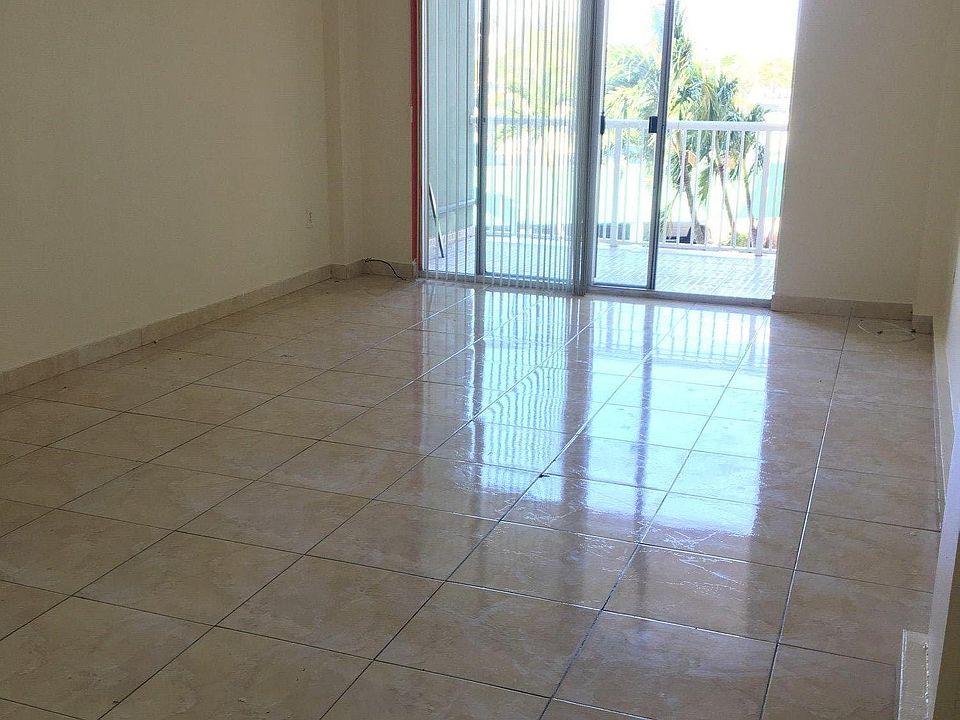 Living/dining room with balcony view.