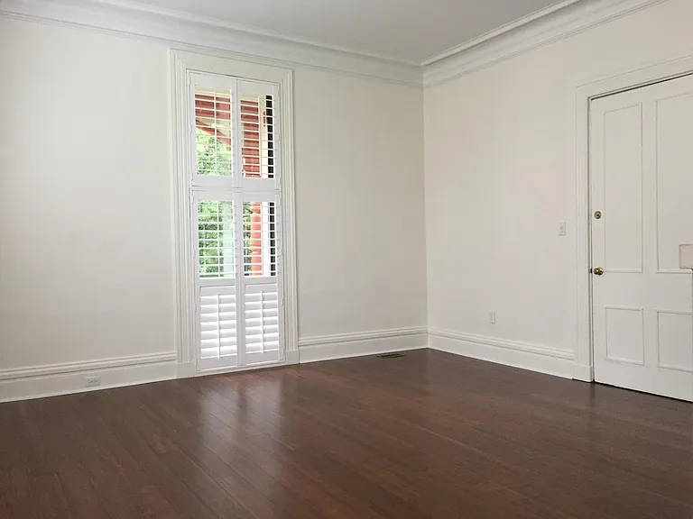 Living Room with large windows and wooden shutters