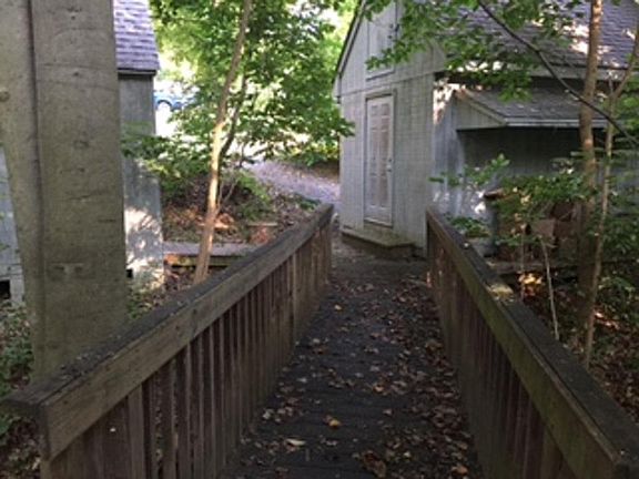 Back yard on bridge over creek to Storage and off street parking