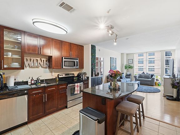 Spacious kitchen featuring a large center island, granite countertops, and stainless steel appliances.