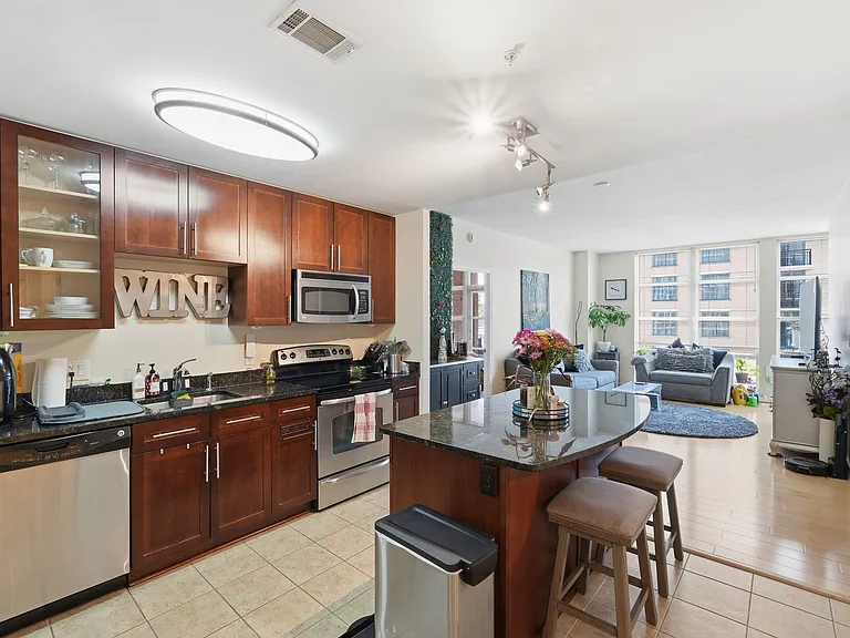 Spacious kitchen featuring a large center island, granite countertops, and stainless steel appliances.