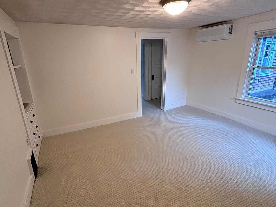 Living room with built in hutch and mini split AC unit