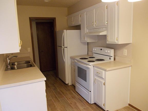 Through kitchen to the garage is the standard size washer and dryer hook-ups that sit across from one another and cabinets above on either side