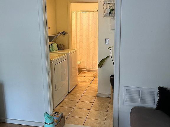 washer dryer area leading into bathroom