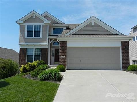 Multi-gabled roof and brick front accents the exterior of this three to four bedroom patio home.