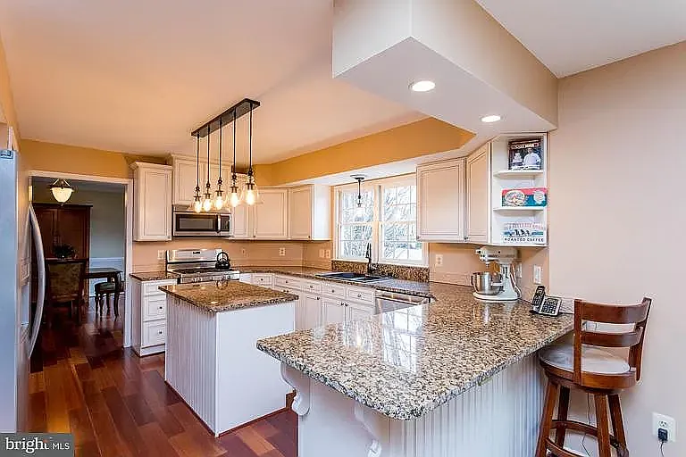 prep area of kitchen, the kitchen has been repainted and has brand new LARGE refrigerator, LARGE dishwasher, motion sensor on the faucet, gas stove and a brand new over the range microwave. There is a large pantry next to the refrigerator.