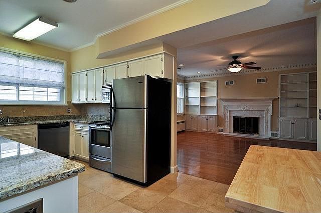 KITCHEN WITH TRAVERTINE TILE FLOOR AND GRANITE COUNTER TOPS