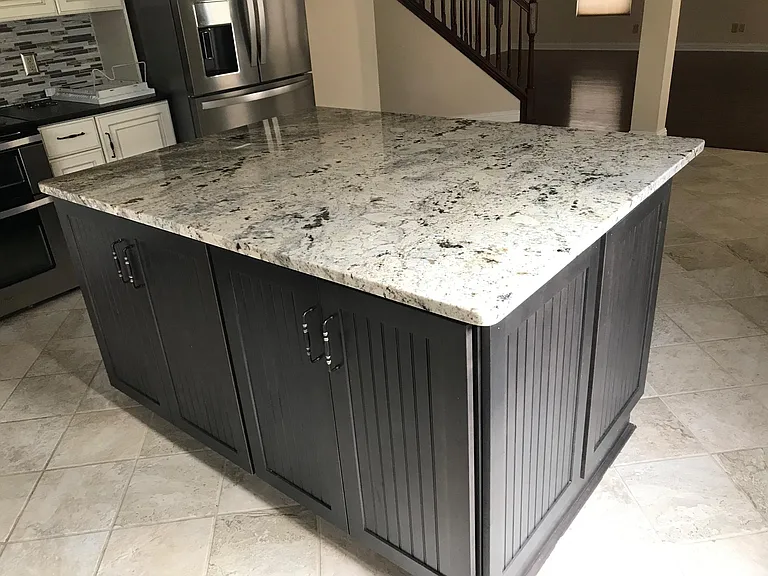 Large Island with shelves on dining room side and drawers and pull outs on sink side.