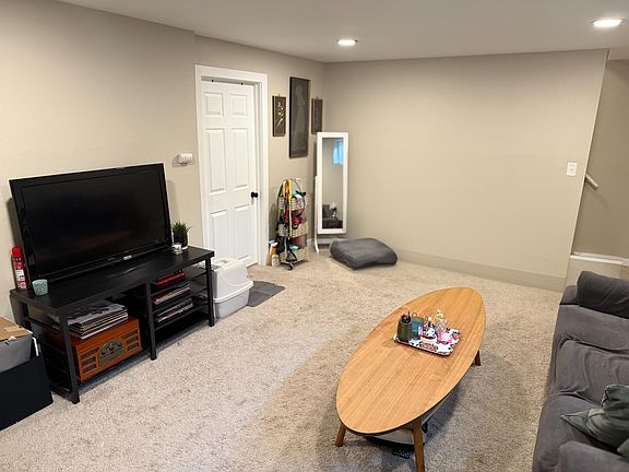 Basement living space with view to the bedroom door