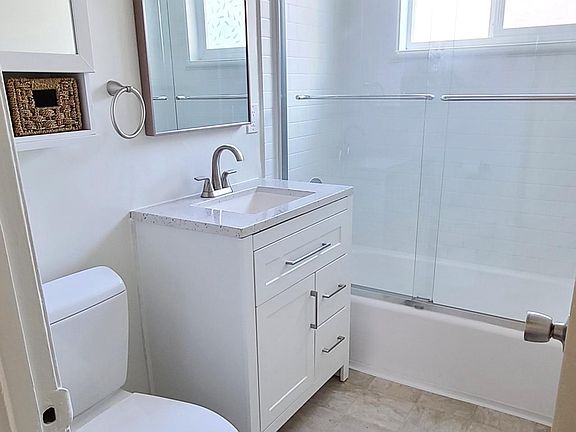 All New Vanity, Mirror, Light, Shower Door, and Shower/Tub.
