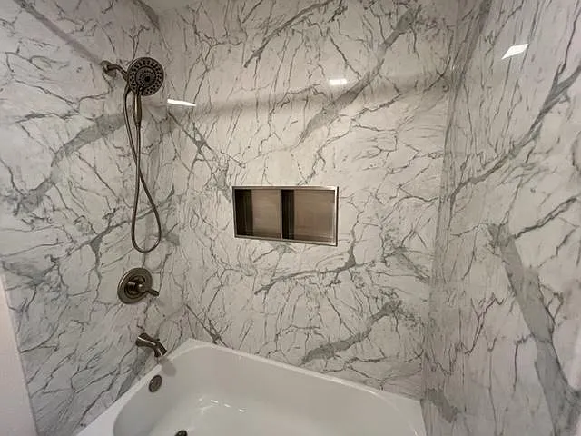 Primary bath surround, removeable shower head and niche