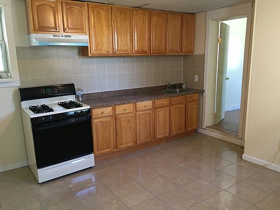 new kitchen with stove and refrigerator