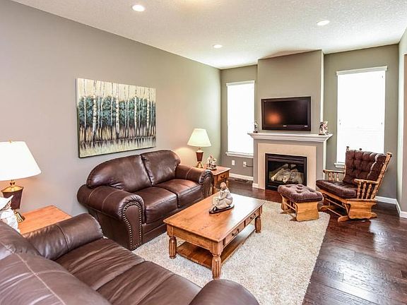Main floor living room with gas fireplace and hardwood flooring.