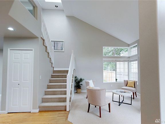 Foyer with formal living room to the right and to the left of the frame is the formal dining room.