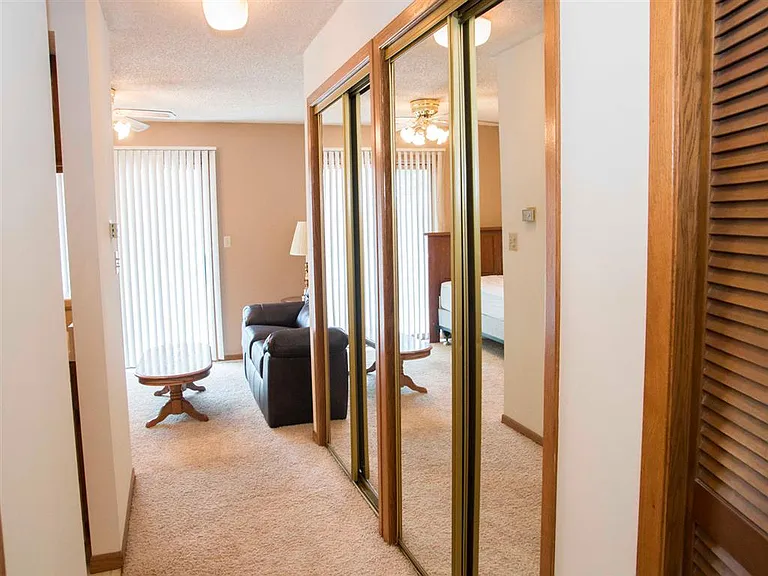 Enjoy everyday convenience with mirrored closets, cozy carpeted floors, and a bright living area just steps away.